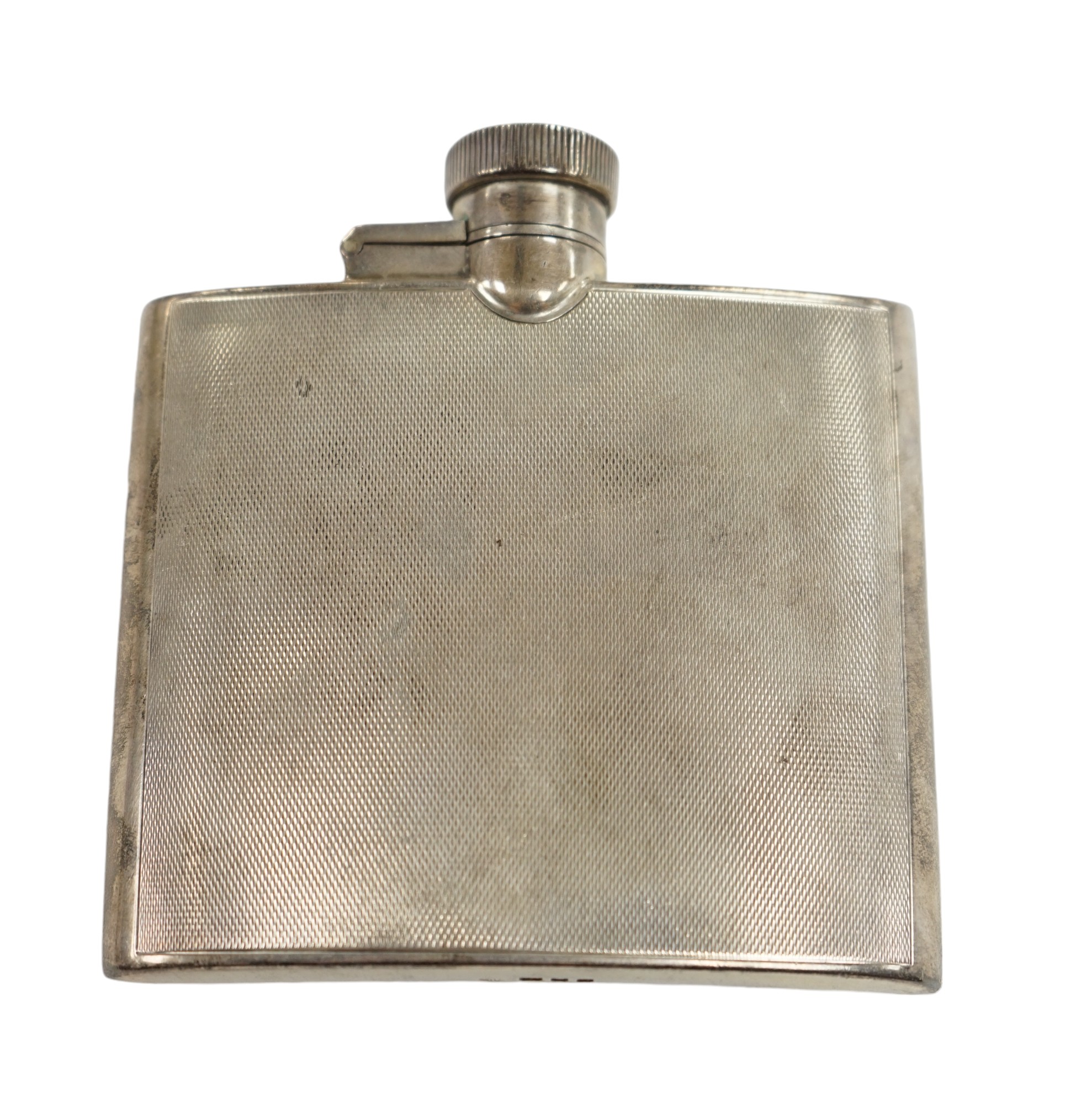 A George VI engine turned silver hip flask, Goldsmiths & Silversmiths Co Ltd, London, 1937, 95mm. Condition - fair